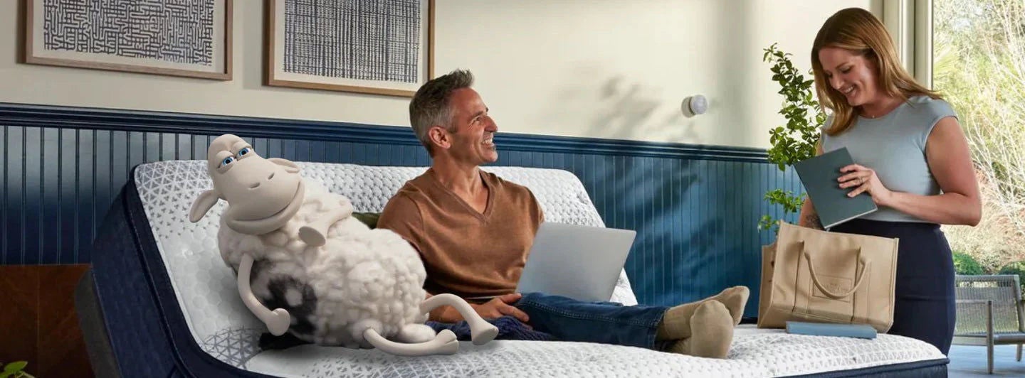 Man relaxing on adjustable mattress with laptop