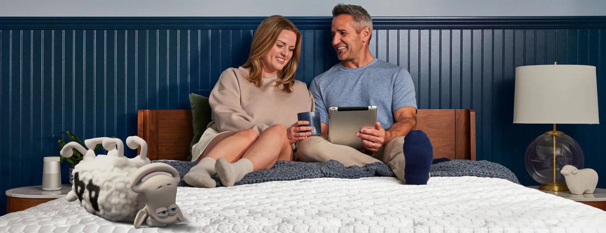 Couple relaxing on bed with devices