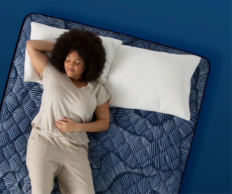 Woman relaxing on patterned mattress