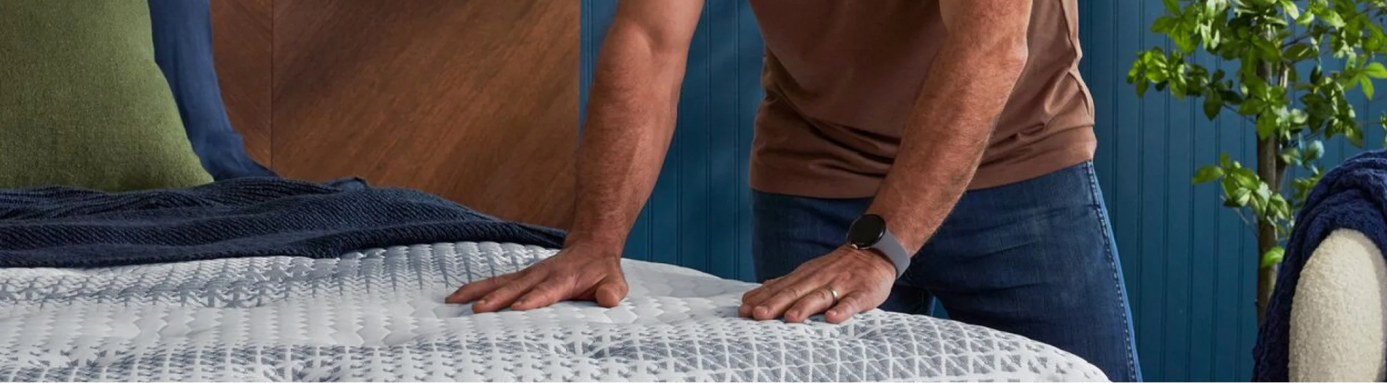 Man testing mattress in modern bedroom