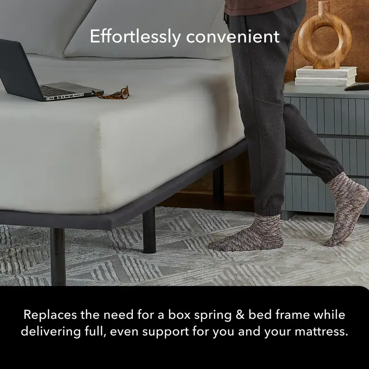 A person wearing dark pants and patterned socks walks beside a bed with a mattress, with overlaid marketing text reading 'Effortlessly convenient' and a claim about replacing a box spring and a black Baselogic Platformbed frame.