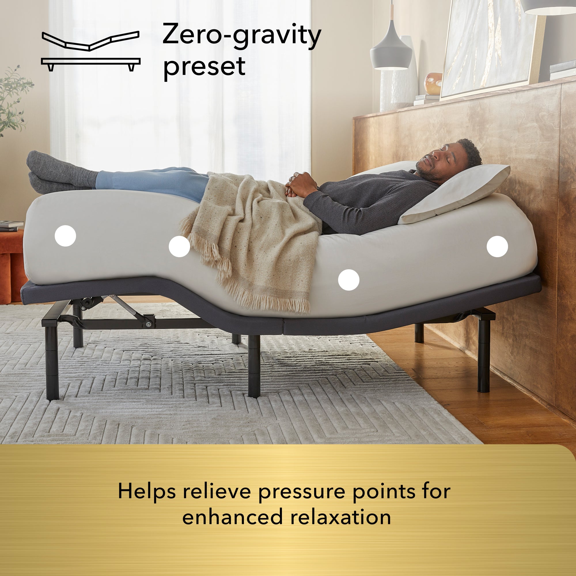 Man laying asleep on a white mattress sitting on a Baselogic Gold Adjustable Base